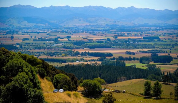 A wide view of farmlands and hills in Wellington