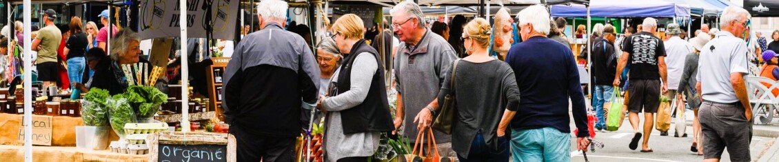 People shopping at a crowded farmers' market